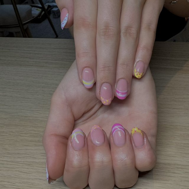 Pastel swirl and dotted French tip nail art in pink, yellow and lilac