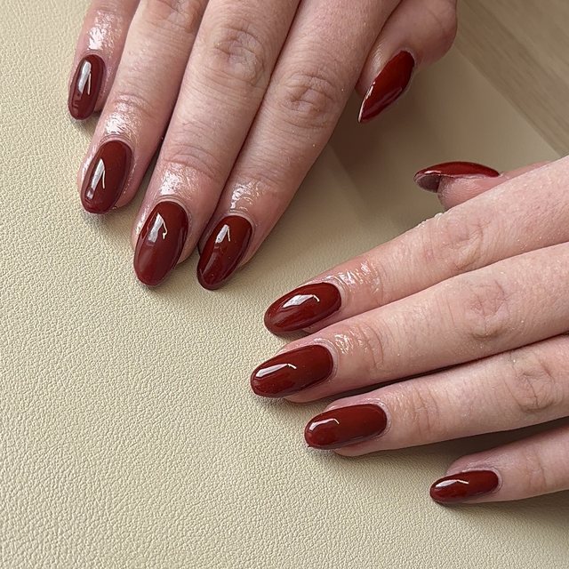 Glossy deep red almond BIAB nails