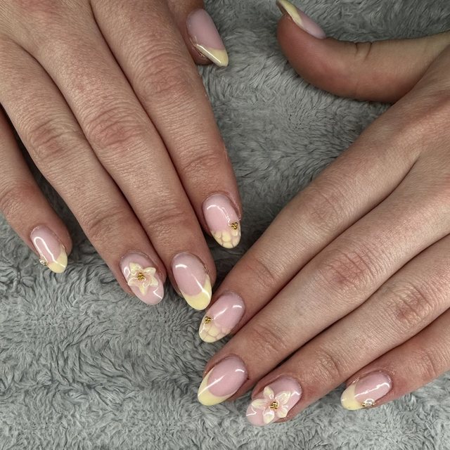 Soft yellow French tips with 3D flower and gold bead detail