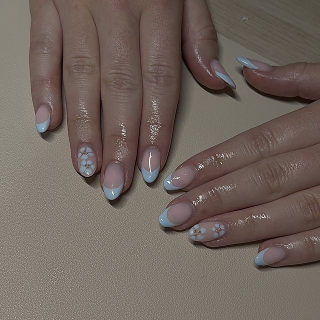 Pale blue French tips with white flower accents